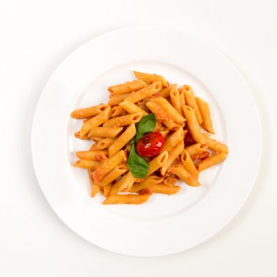 Overhead shot of Penne Ala Vodka on a white dinner plate against a white background