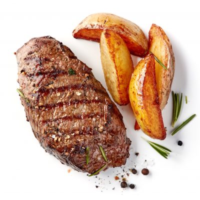 grilled beef steak and potatoes isolated on white background, top view