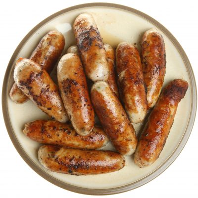 Chargrilled pork sausages piled on a plate.